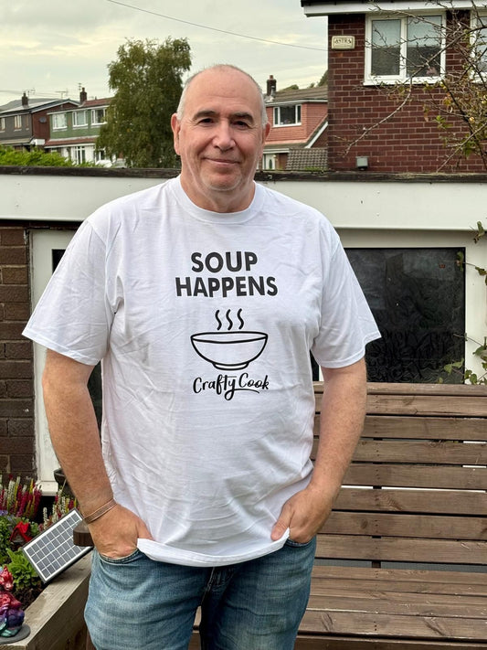 Crafty Cook Soup Happens T-shirt in all sizes, featuring a humorous soup-themed graphic on a casual cotton shirt.