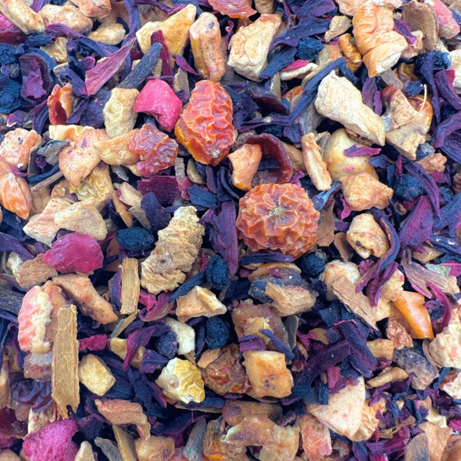 Porter Hill Tea Company Cranberry Apple Tart Fruit & Herbal tea in a teacup, showcasing bright red cranberries and apple slices.
