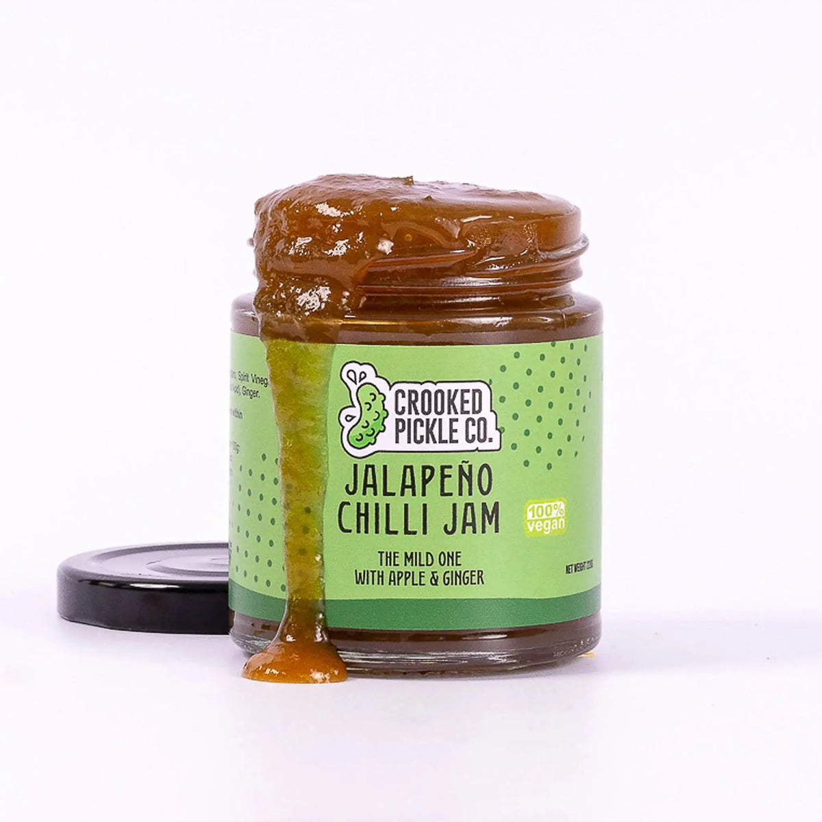 Jalapeño chili jam from Crooked Pickle Co in a clear jar, showcasing vibrant green jalapeños and glossy jam texture.