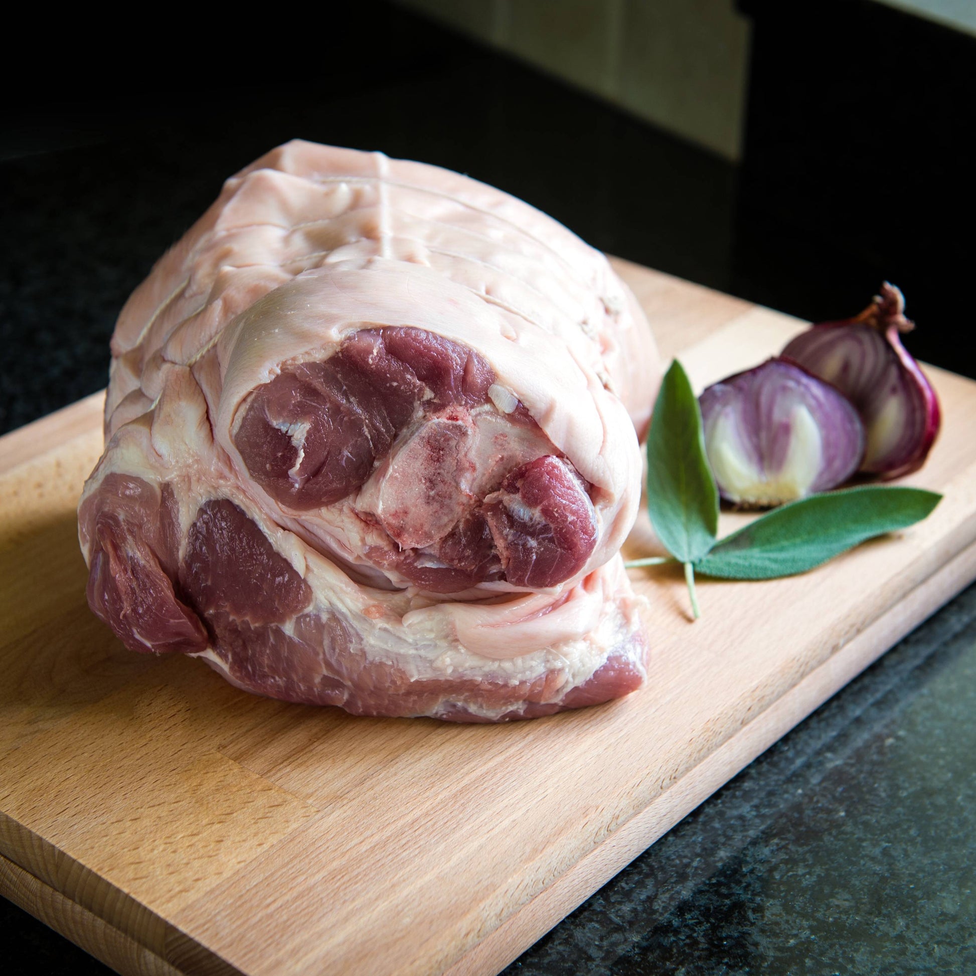 Bone-in pork shoulder joint from Primrose Herd, showing a fresh, marbled pork cut ideal for roasting or slow cooking.