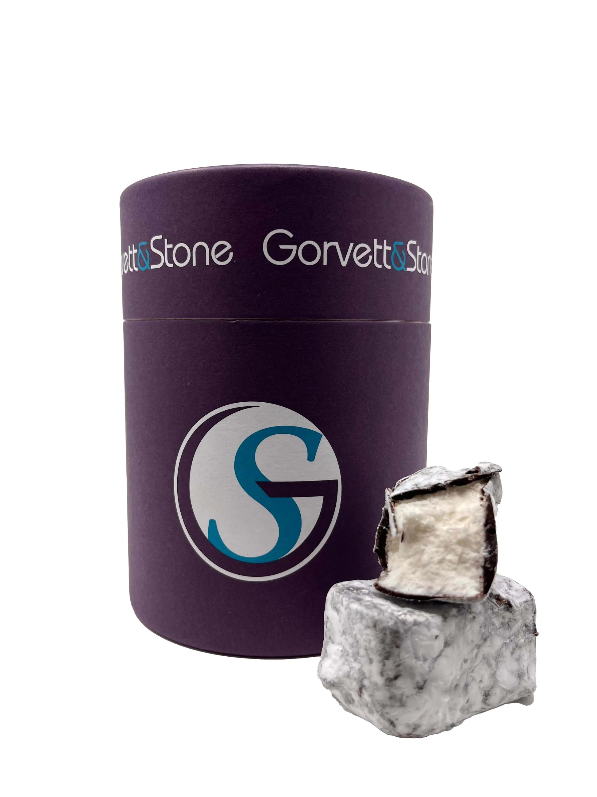 Gorvett & Stone honey and vanilla marshmallows dipped in dark chocolate in a tub, with a glossy dark chocolate coating.