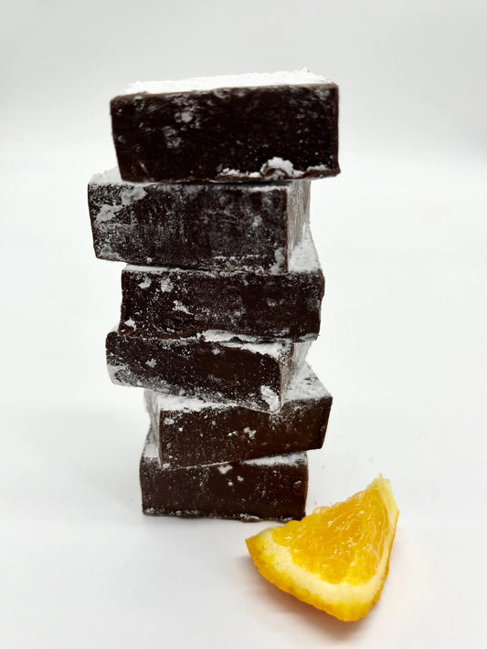Gorvett & Stone dark chocolate orange meltaways, rich chocolate squares with orange flavor, arranged on a white plate.
