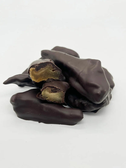 Dark chocolate-covered pear from Gorvett & Stone, showcasing a glossy chocolate coating on a fresh pear.