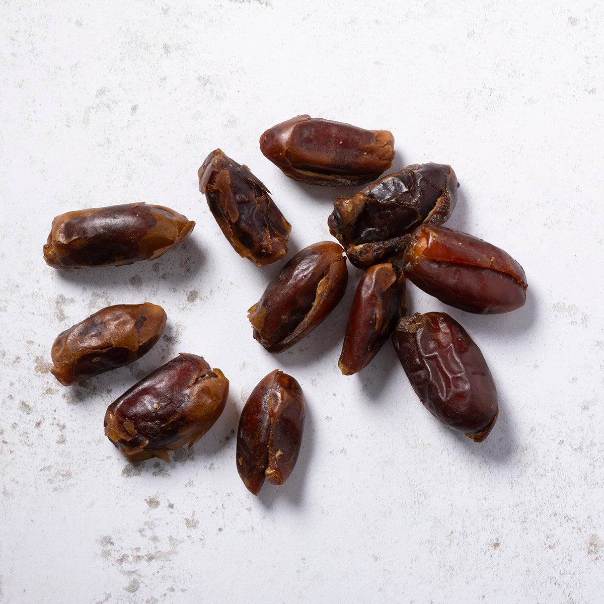 Pitted dried dates from Whole Food Earth in a freeflow container, showing the chewy, dark brown fruit texture