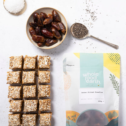 Pitted dates from Whole Food Earth in a free-flowing dried fruit package, showcasing glossy, dark brown dates ready to eat.