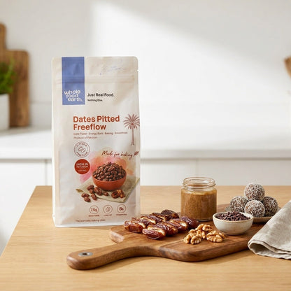 Pitted free-flow dried dates from Whole Food Earth displayed in a bowl on a wooden surface.