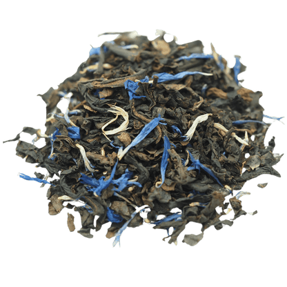 Decaf Earl Grey black tea by Porter Hill Tea Company in a teacup with loose tea leaves and a lemon slice on a wooden table