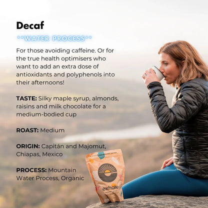 Organic decaf coffee from Exhale Healthy Coffee, showing a brewed cup with rich, dark coffee and a coffee bean on a wooden table.