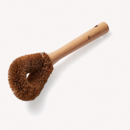 Wild And Stone coconut fibre dish brush with wooden handle, designed for effective dish cleaning and scrubbing.