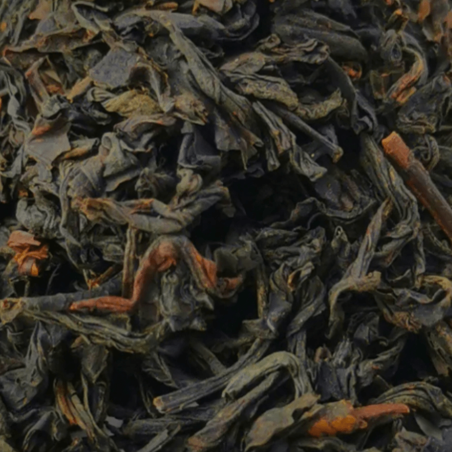 Porter Hill Tea Company's Emperor Butterfly Lapsang Souchong black tea in a loose leaf form with fragrant smoky aroma.