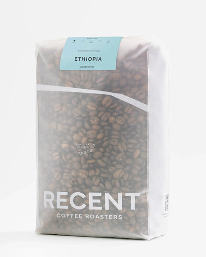 Ethiopian Awash River medium roast coffee beans from Recent Beans, 1kg bag with whole beans in a natural setting.