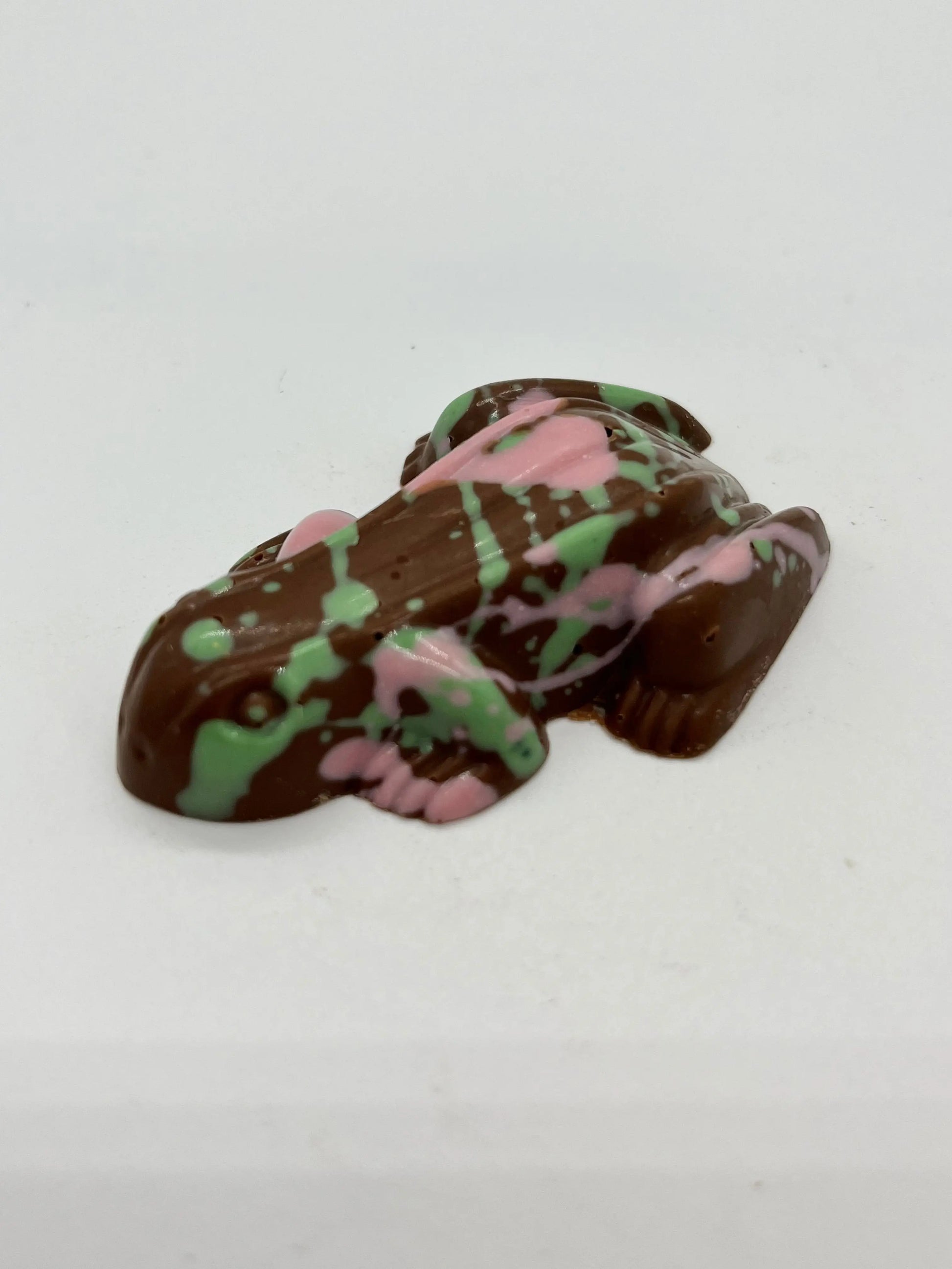 Pink and green exploding chocolate frog by Gorvett & Stone, detailed candy with vibrant colors and playful design.