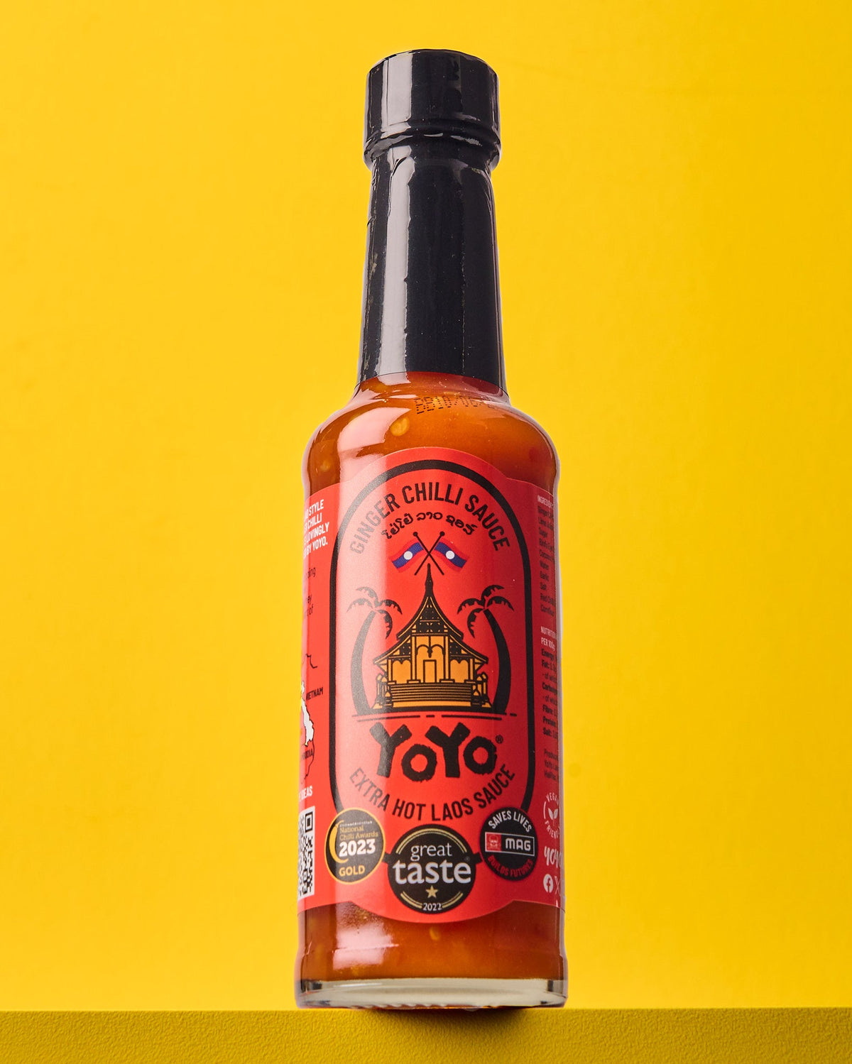 Spicy extra hot ginger chili sauce in a jar by YoYo Laos Sauce, showcasing vibrant red chili and fresh ginger pieces.