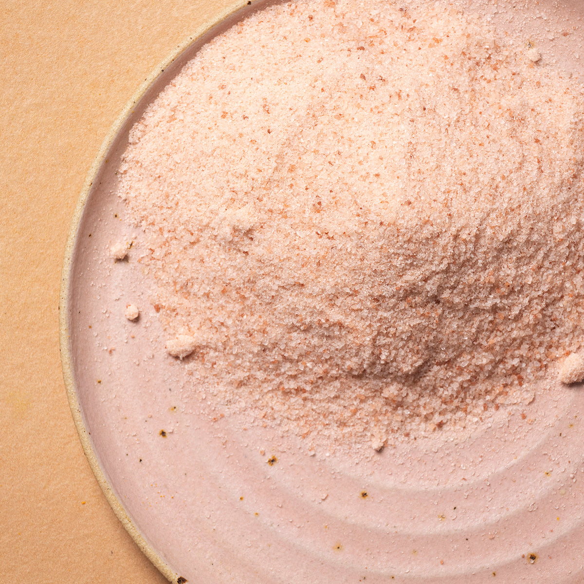 Fine Himalayan salt crystals from Whole Food Earth, showcasing the mineral-rich pink salt in a natural, granular form.