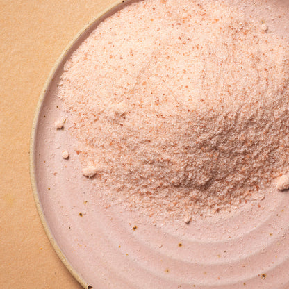Fine Himalayan salt crystals from Whole Food Earth, showcasing the mineral-rich pink salt in a natural, granular form.