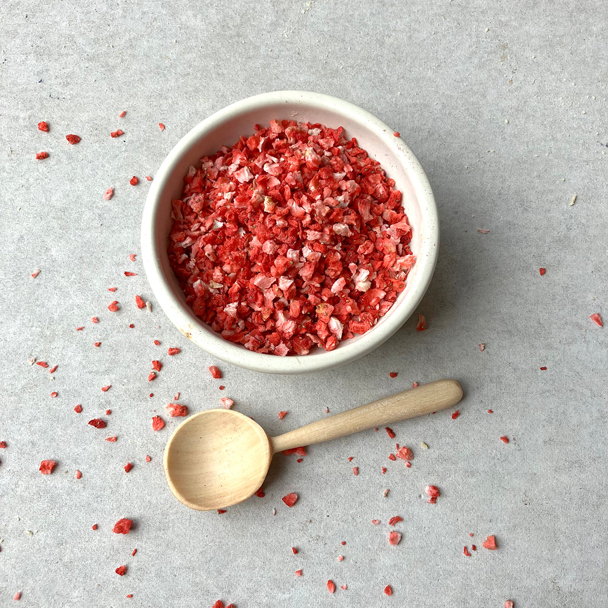 Freeze dried strawberry crumbs from Whole Food Earth, showing vibrant red dried fruit pieces with a crunchy texture.