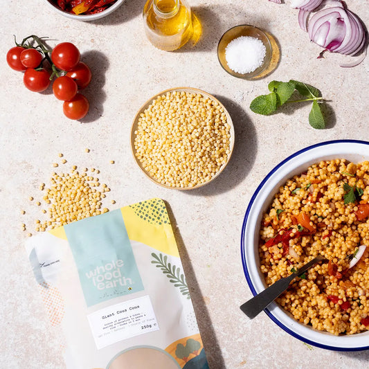 Large serving of artisan giant couscous in a bowl, showcasing its fluffy texture and golden color, ideal for healthy meals.