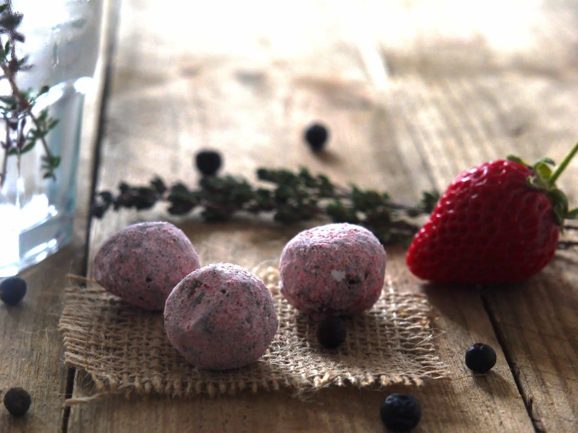 Gorvett & Stone Strawberry Gin Fizz truffles with pink and white coating and decorative sprinkles on top.