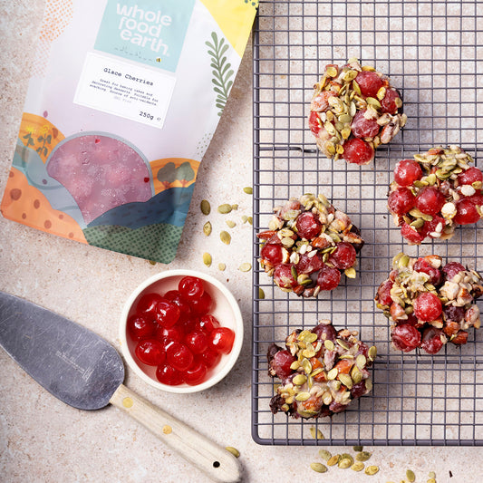 Dried glace cherries from Whole Food Earth, showing glossy red cherries in a natural setting with a rustic background.