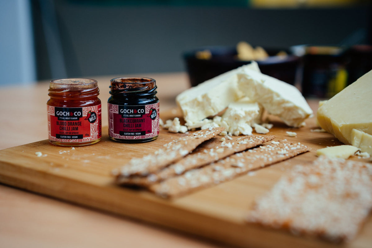 Blackcurrant chili jam by Goch & Co, showing a jar filled with vibrant, dark jam containing visible blackcurrants and chili flakes.