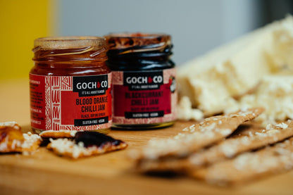 Assorted sweet and savory chili food items in Goch & Co gift set, featuring various colorful chili sauces and condiments.
