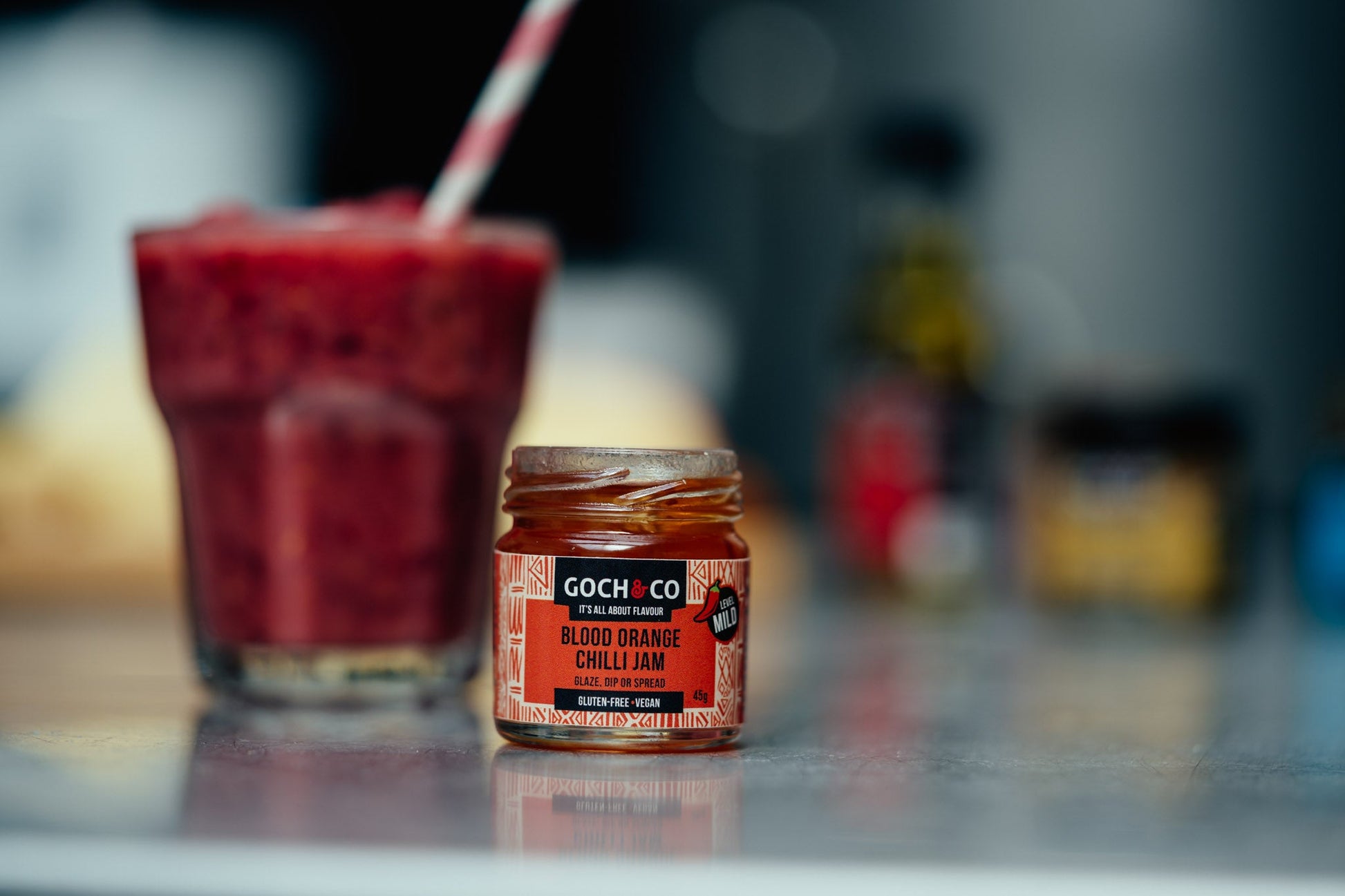 Goch & Co Blood Orange Chilli Jam jar with vibrant red-orange jam and fresh chili peppers on the label.