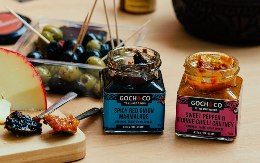 Sweet pepper and orange chilli chutney by Goch & Co, showcasing vibrant orange and red chutney in a jar.
