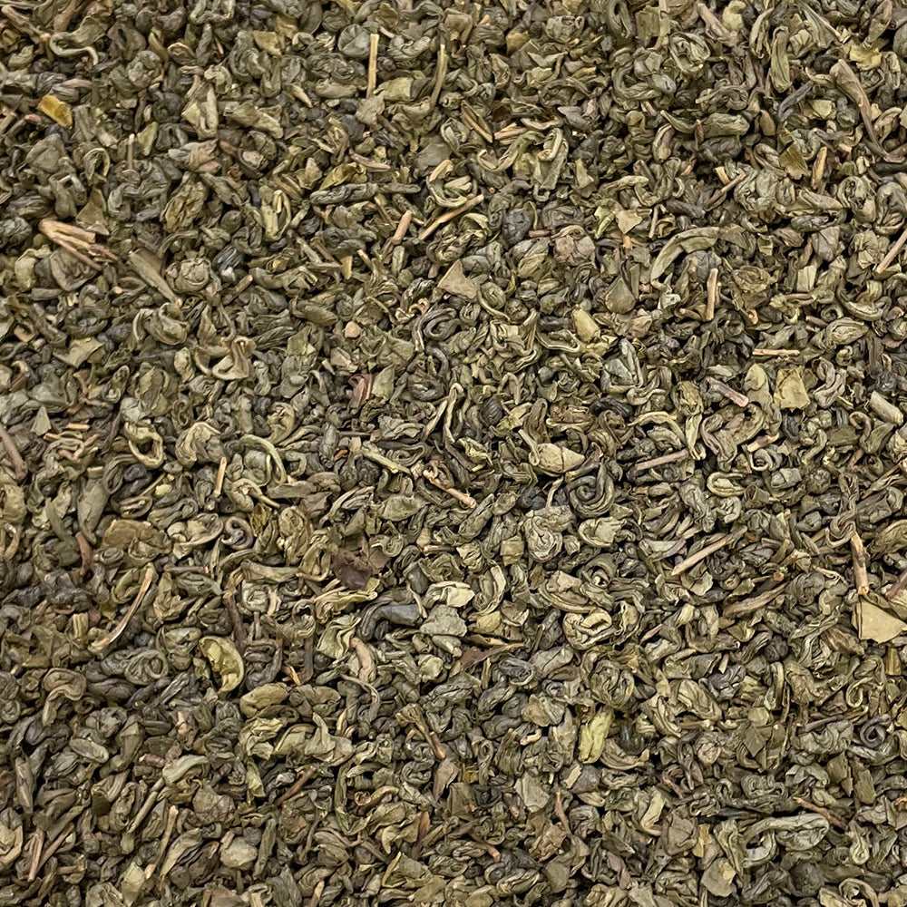 Loose leaf Gunpowder tea called Temple of Heaven by High Teas, showcasing tightly rolled green tea leaves in a natural setting.