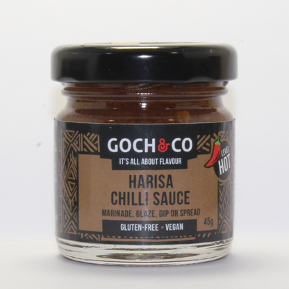 Spicy Harisa chili sauce in a jar from Goch & Co with red chili peppers and rich, flavorful texture.