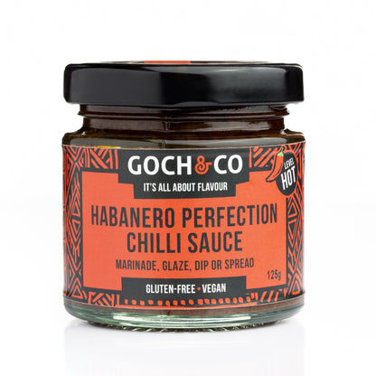 Goch & Co Habanero Perfection Chilli Sauce bottle with vibrant label and fresh habanero peppers beside it, highlighting spicy flavor.