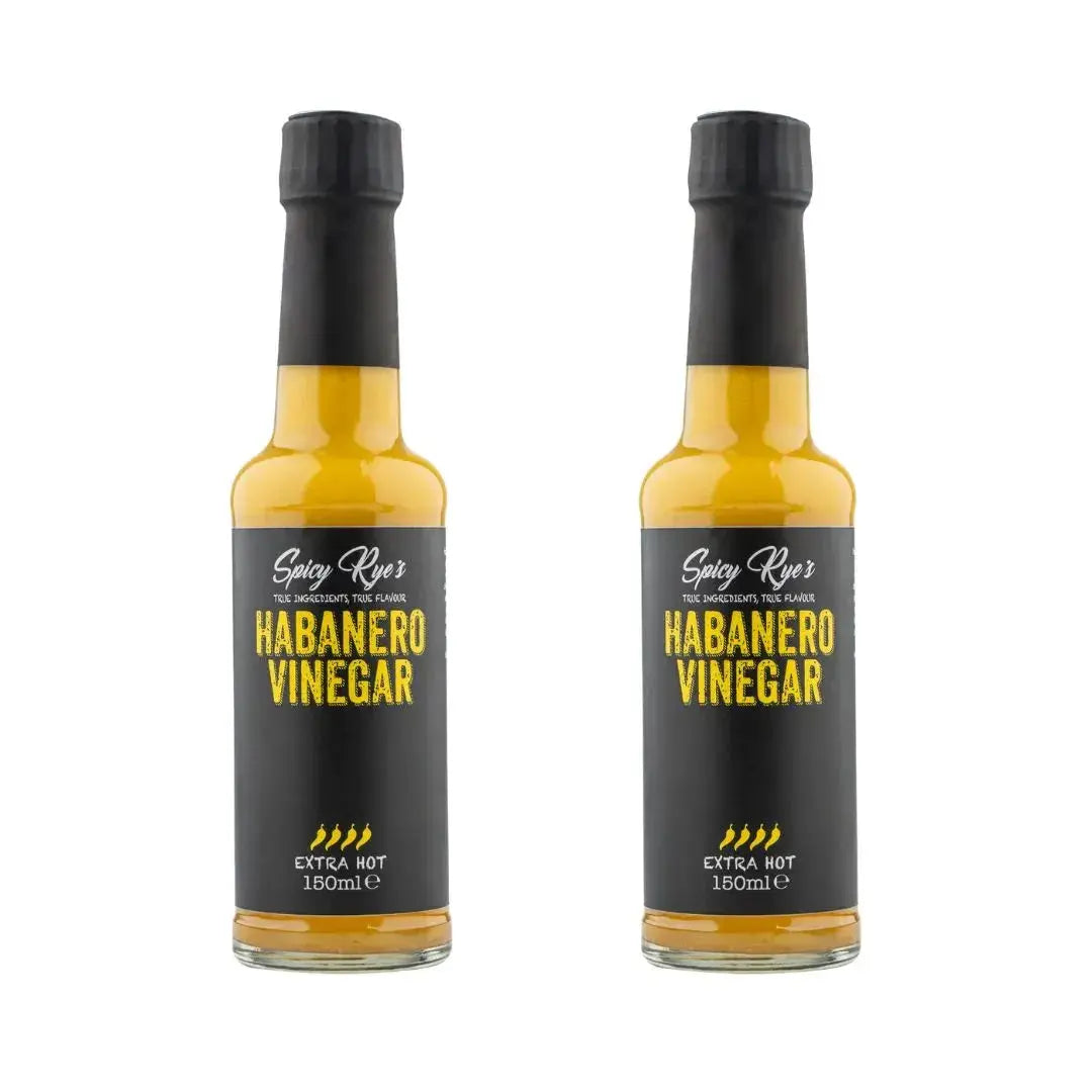 Two bottles of Spicy Ryes Habanero Vinegar with bright orange habanero peppers on the labels.