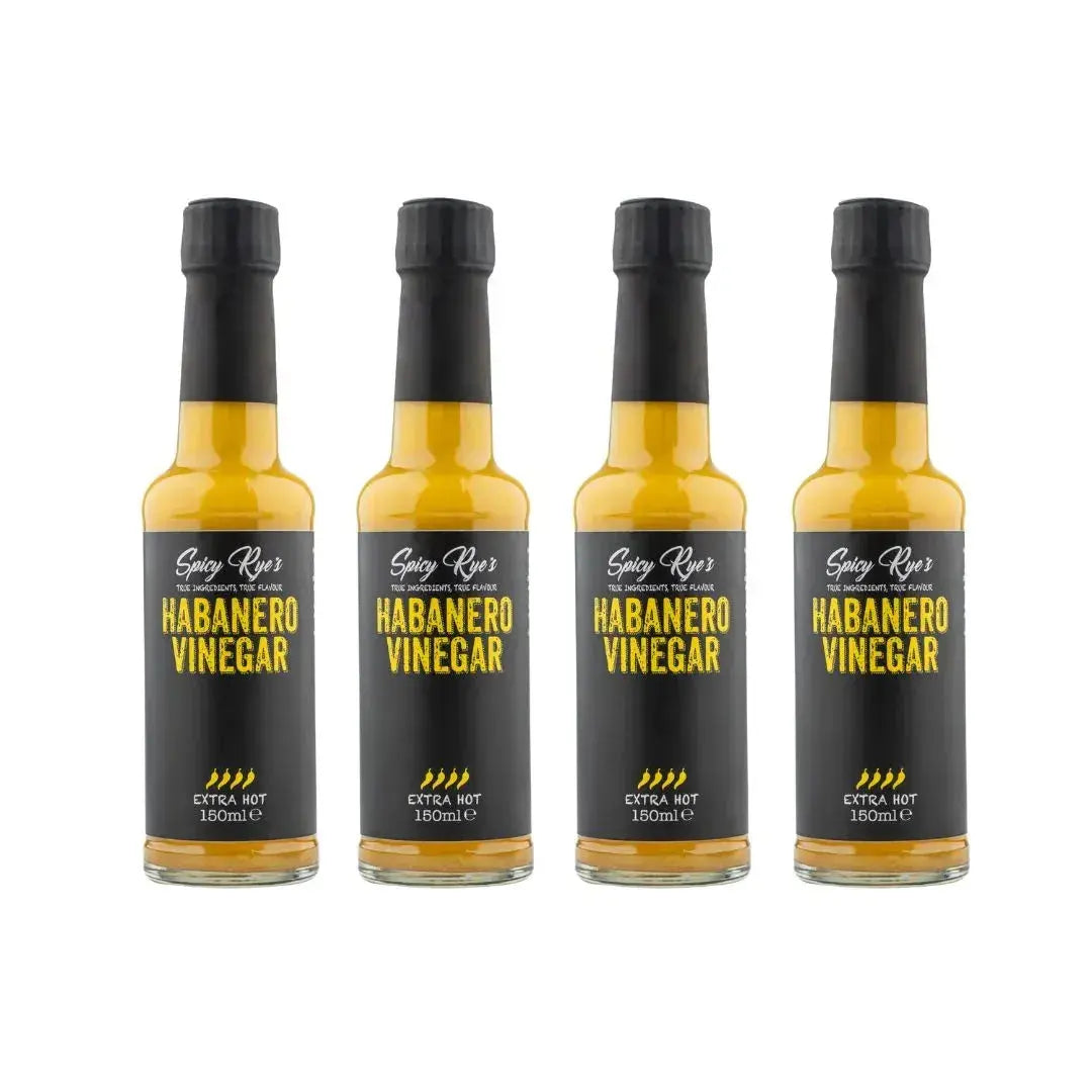 Four bottles of Spicy Ryes Habanero Vinegar with vibrant red habanero peppers and clear glass bottles on a white background.