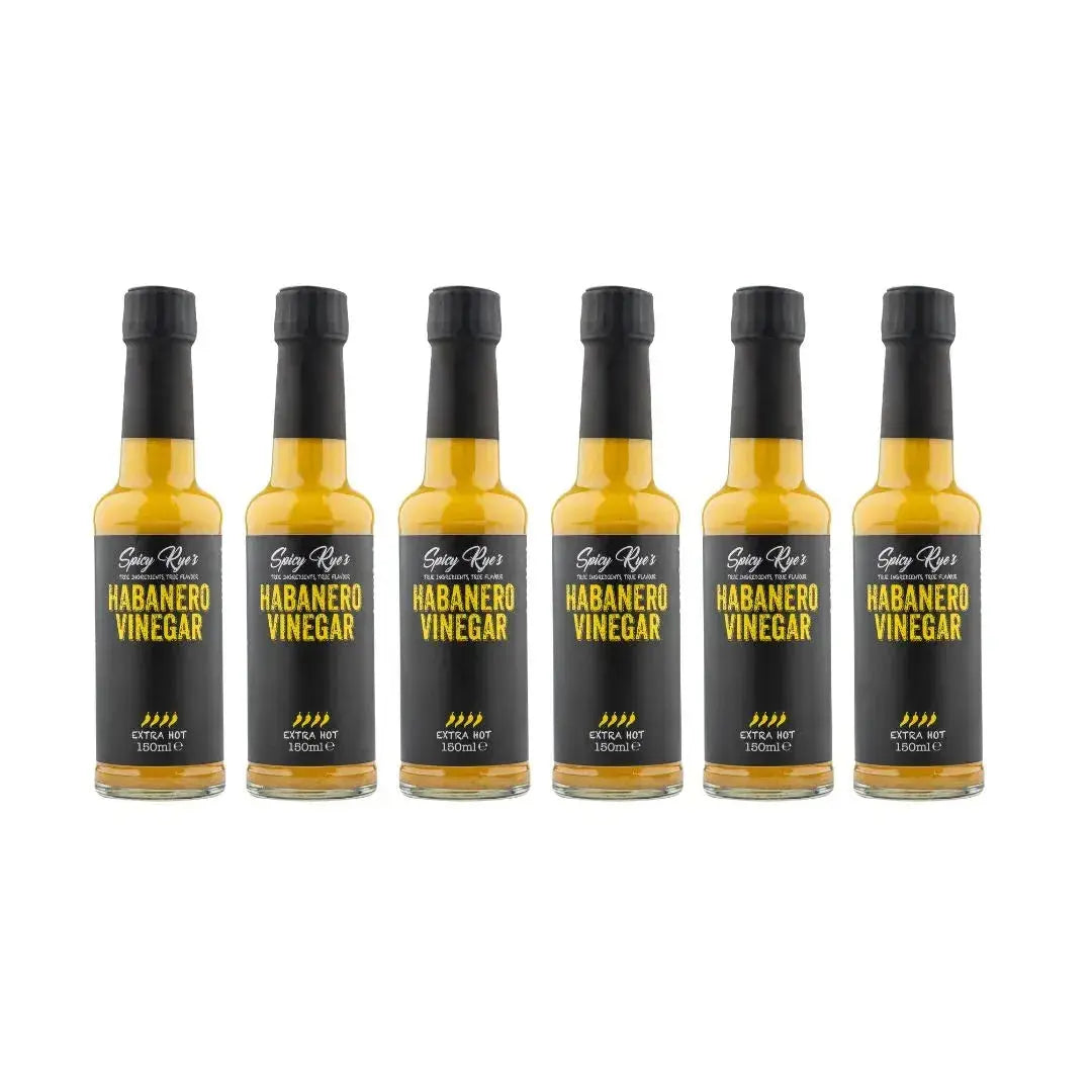 Six bottles of Spicy Ryes habanero vinegar with bright red peppers and label, showcasing the spicy condiment for cooking and flavoring.