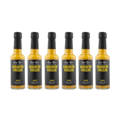 Six bottles of Spicy Ryes habanero vinegar with bright red peppers and label, showcasing the spicy condiment for cooking and flavoring.