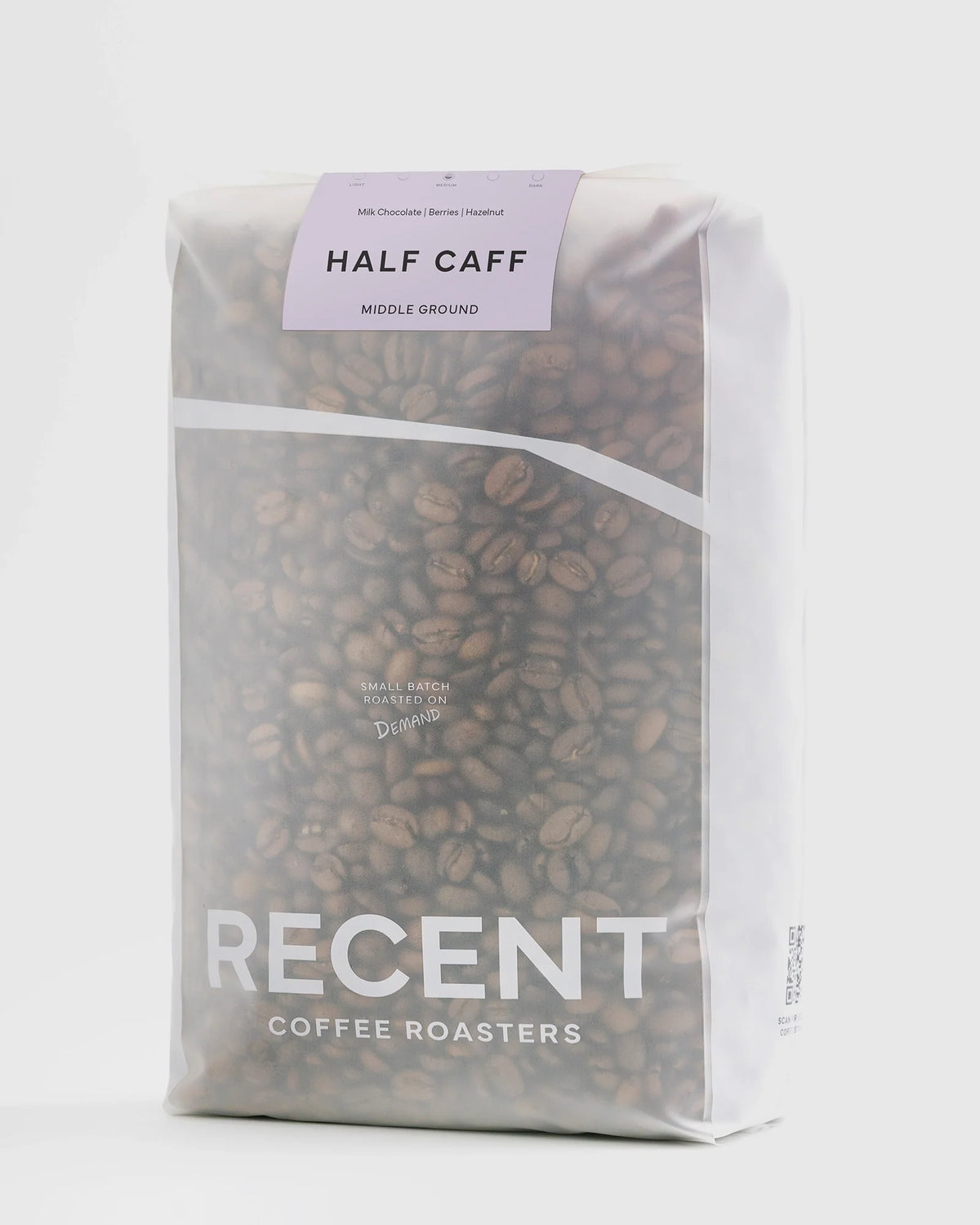 Half-caff Middle Ground medium roast coffee beans from Recent Beans in a 1kg bag, showcasing the coffee grounds.