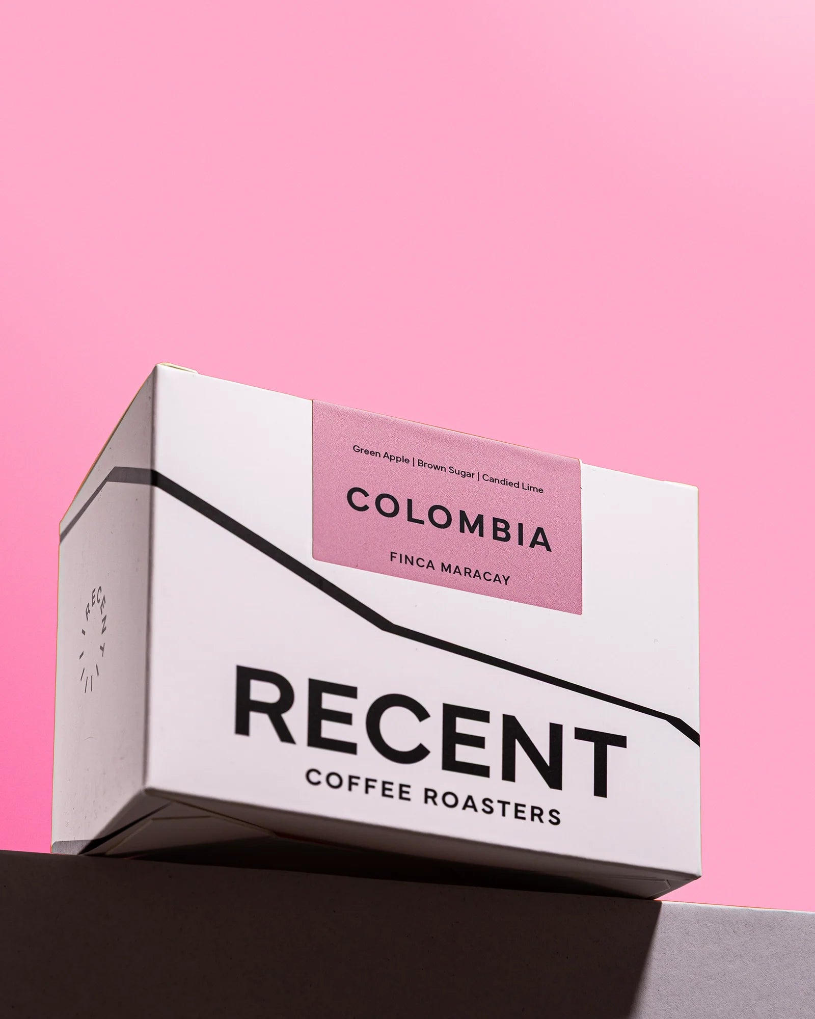 Half-caff Colombia Finca Maracay coffee from Recent Beans, showing roasted coffee beans in a natural setting.
