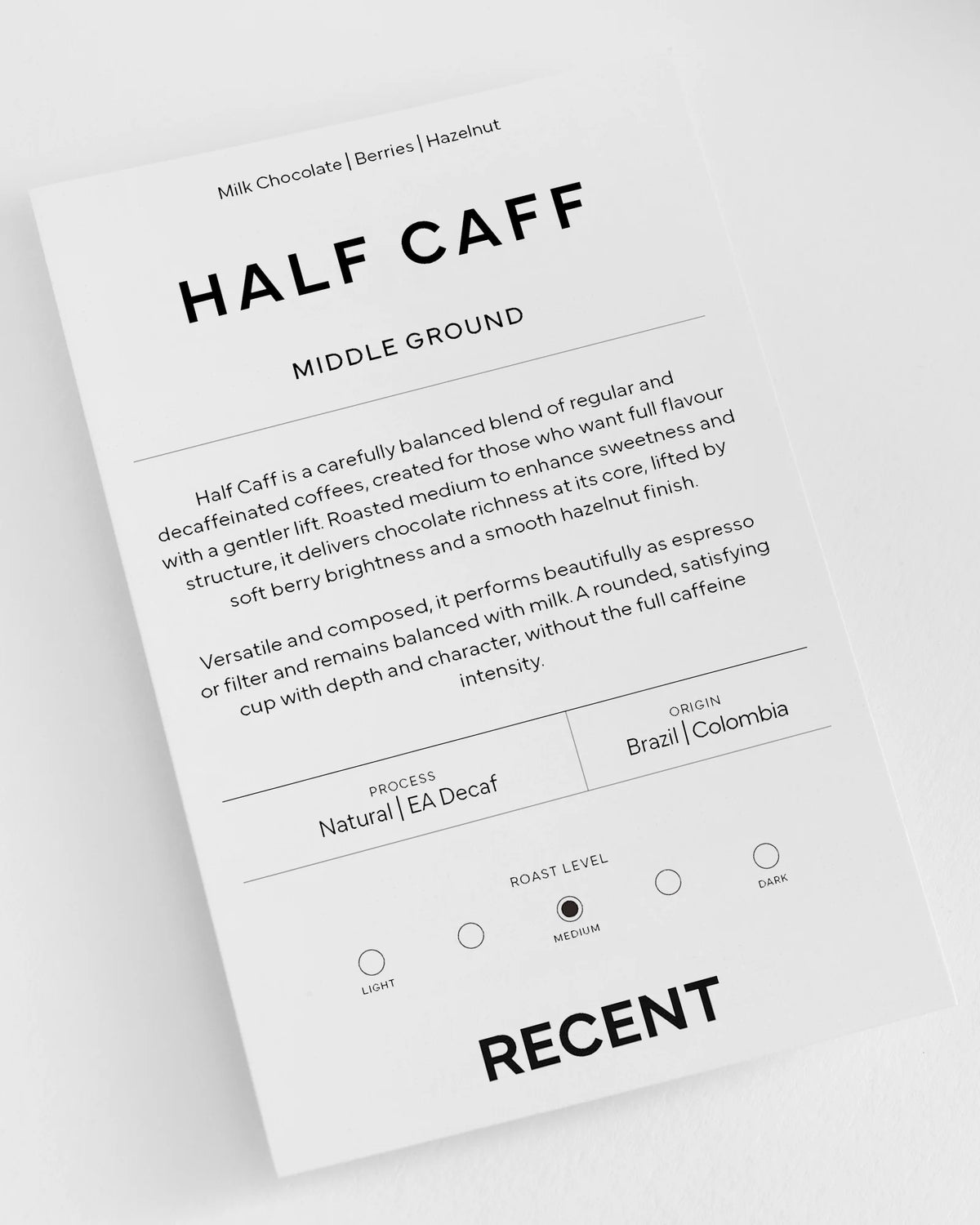 Half-caff Colombia coffee from Recent Beans, showcasing medium roast beans in a close-up shot.