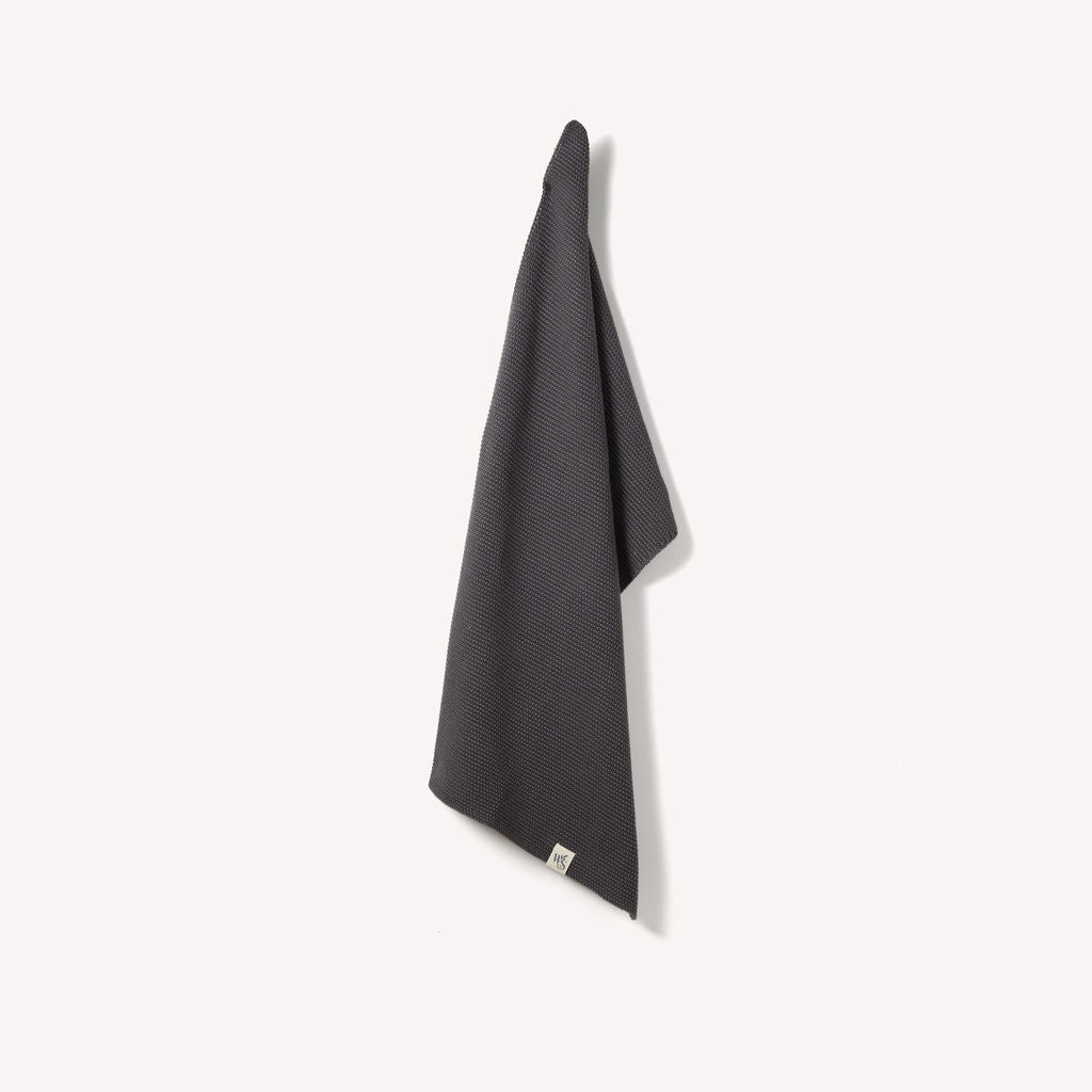 Organic cotton hand towel from Wild and Stone, soft and absorbent with a woven texture in natural neutral tones.