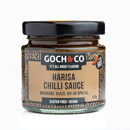 Spicy Harisa chili sauce in a jar by Goch & Co, showcasing a vibrant red color and smooth texture.