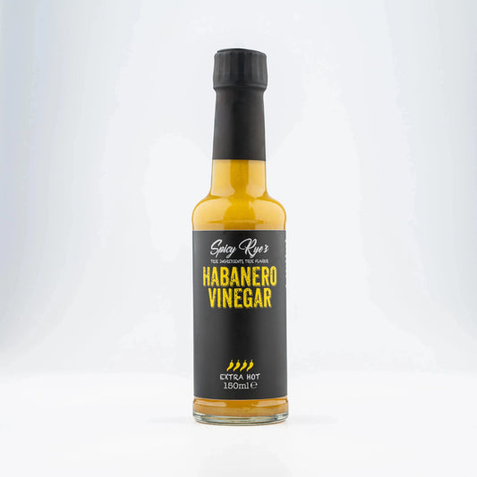 Spicy Ryes habanero vinegar in a clear glass bottle, showing bright orange habanero peppers and liquid inside.