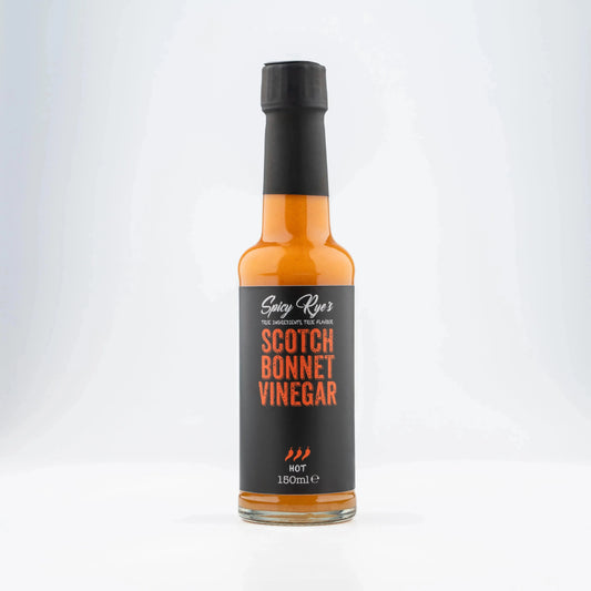 Spicy Ryes Scotch Bonnet vinegar bottle with red label and chili pepper illustration, close-up shot on a white background.