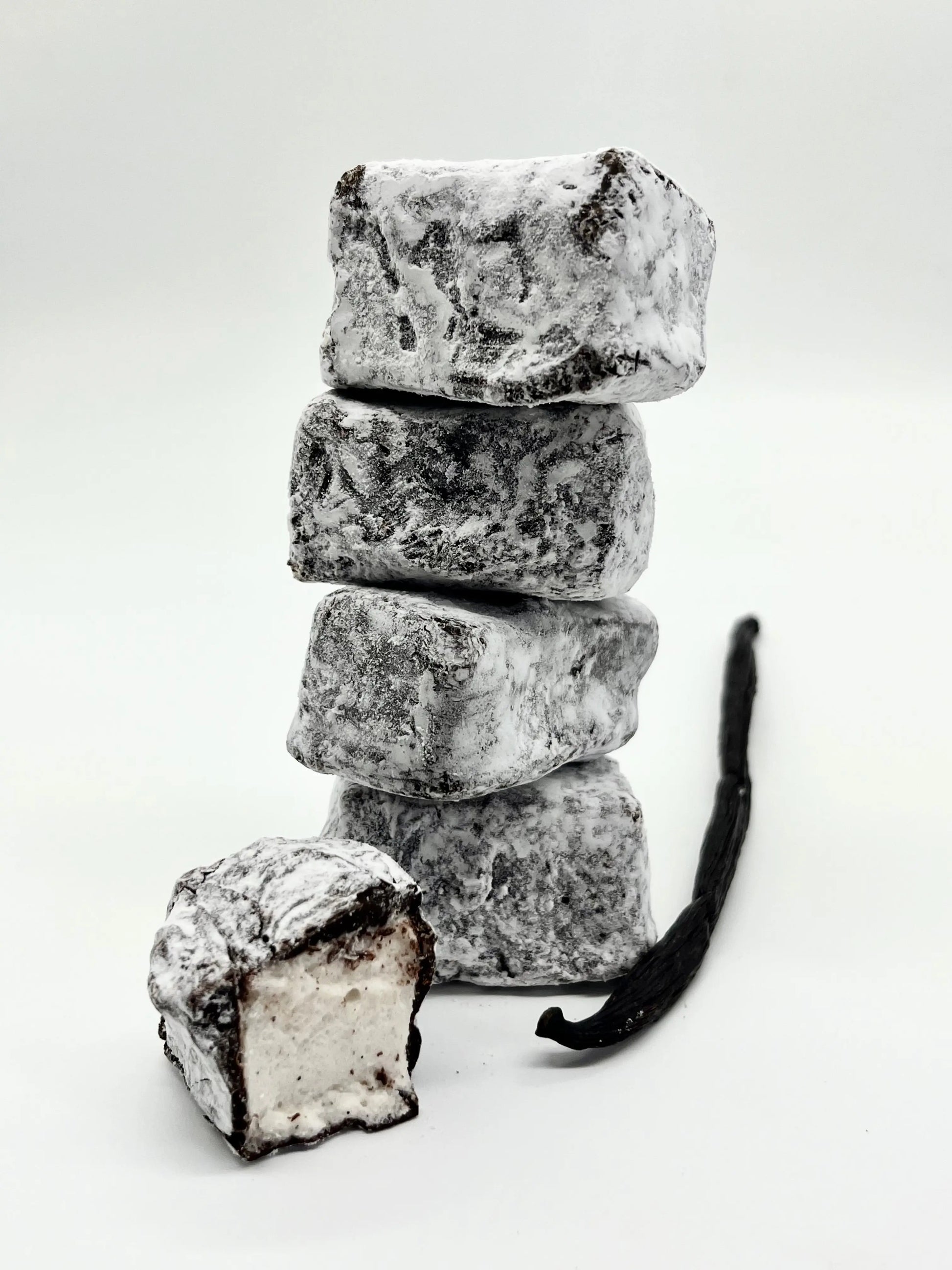 Gorvett & Stone honey and vanilla marshmallow dipped in dark chocolate, showcasing creamy vanilla filling and rich chocolate coating.