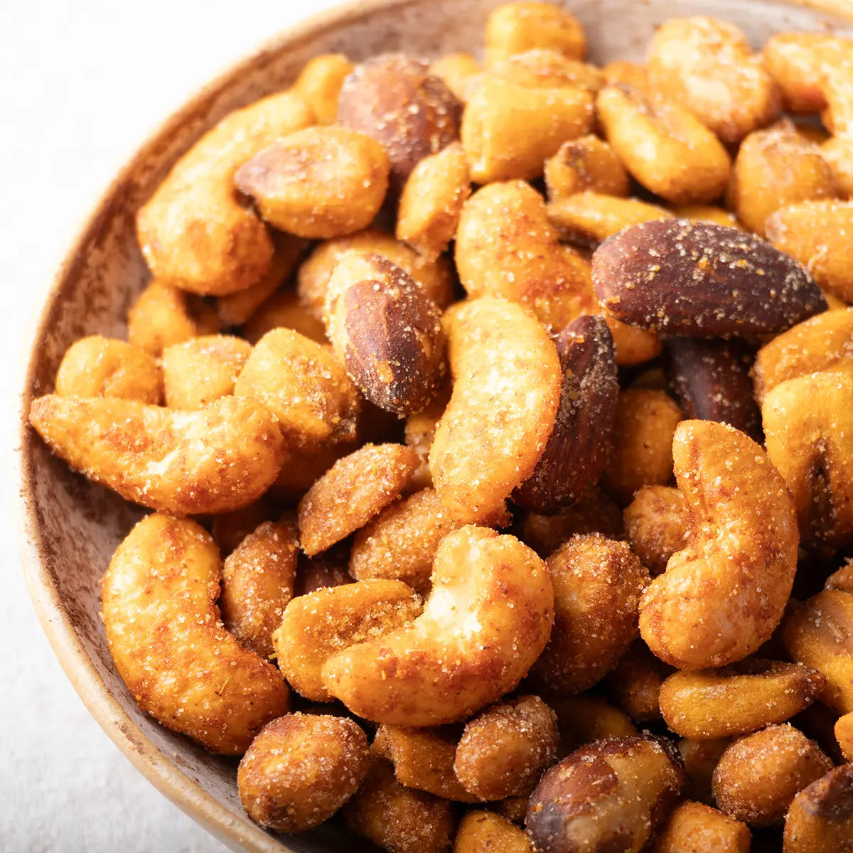 Spicy hot chili mixed nuts from Whole Food Earth, featuring a variety of roasted nuts and seeds coated in chili seasoning.