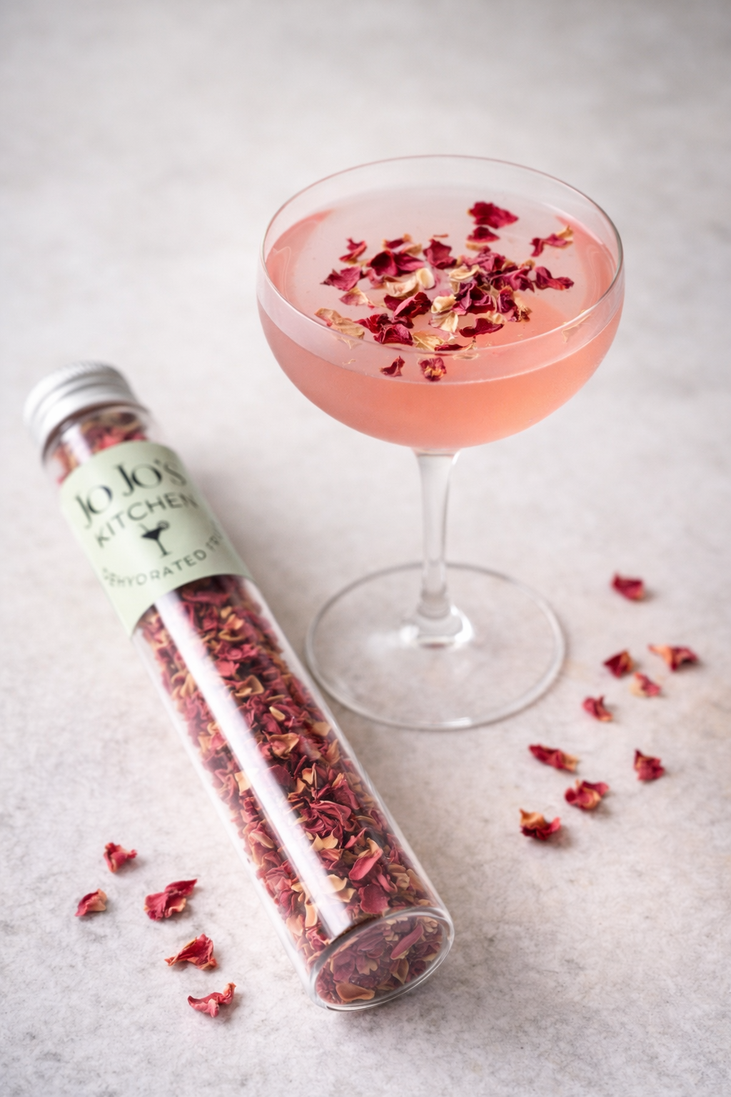Edible rose petals from JoJo’s Kitchen arranged in a bowl for decorative culinary use, vibrant pink and red petals.