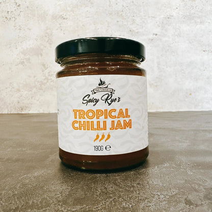 Spicy Ryes Tropical Chilli Jam jar with vibrant label, showcasing the bright orange chili jam inside.