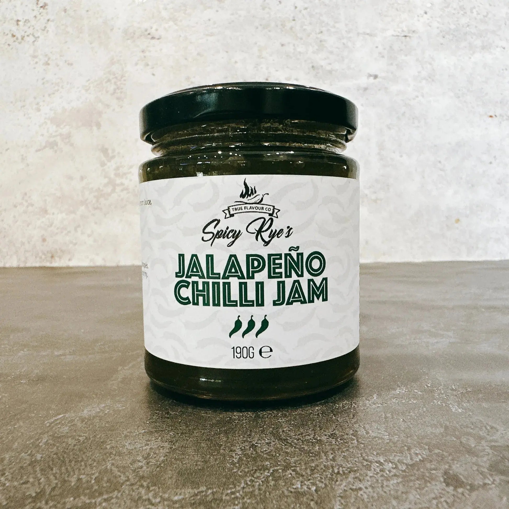 Spicy Ryes Jalapeno Chilli Jam jar with vibrant red jam visible inside, showcasing the spicy, chunky chili preserve.