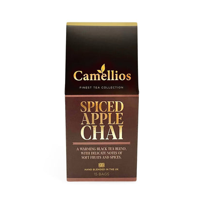 Camellios Spiced Apple Chai tea and infusions in a cozy mug with cinnamon sticks and apple slices on a rustic wooden table