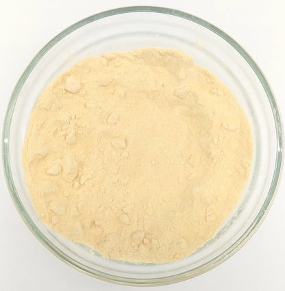 Organic carrot powder from Whole Food Earth, close-up of vibrant orange powdered herb on a white background.