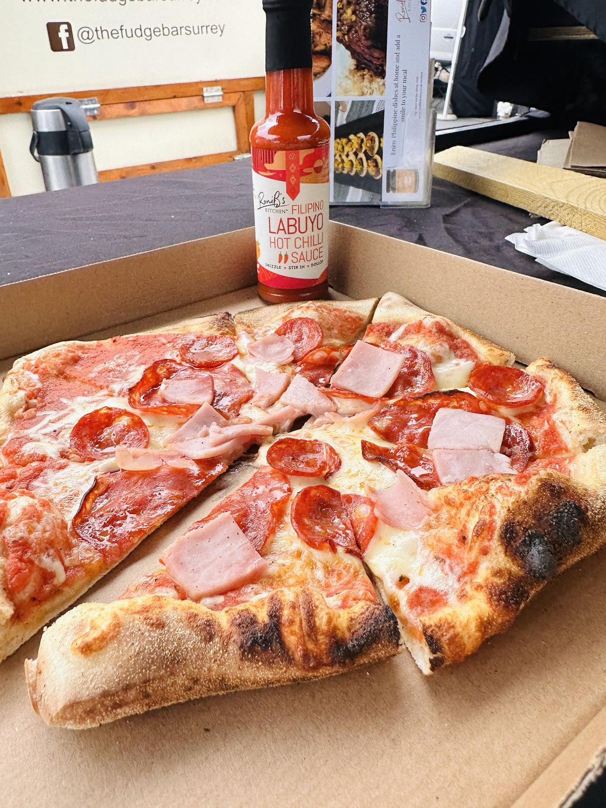 Filipino Style Labuyo Hot Chilli Sauce by RoniBs Kitchen, vibrant red hot sauce in a glass bottle with tropical chili peppers.