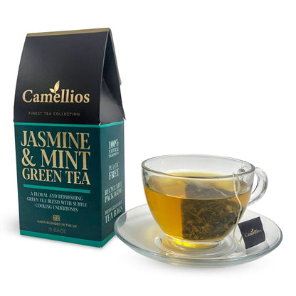 Camellios Jasmine & Mint Green Tea in a glass cup with fresh mint leaves, showcasing the tea's vibrant color and aromatic herbs.